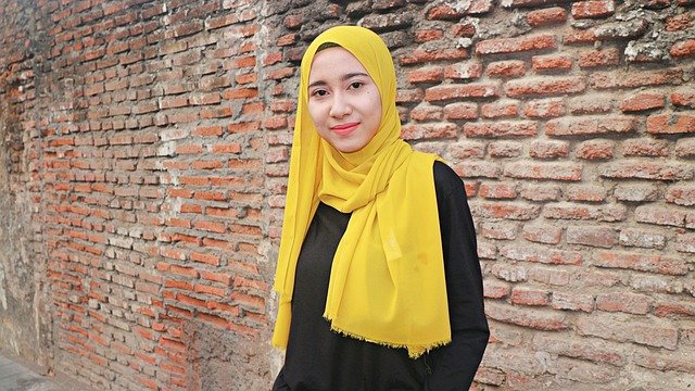 mulher jovem branca com hijab amarelo
