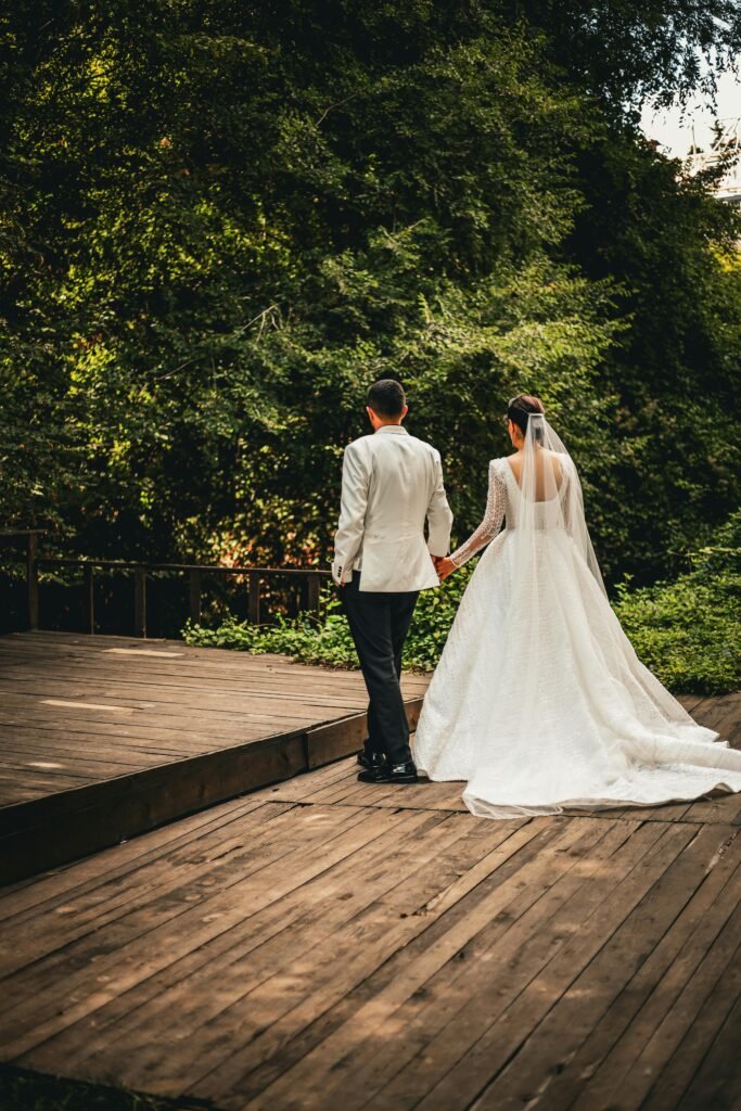 a man and woman holding hands on a wooden deck