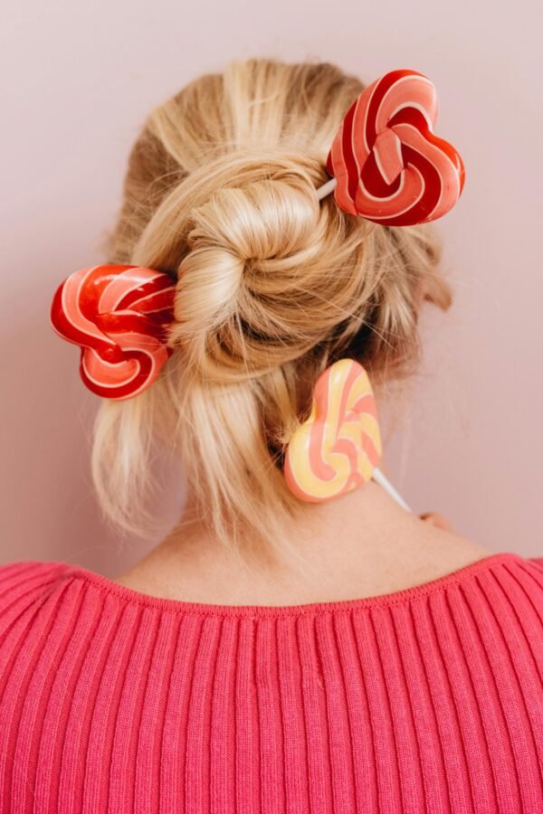 mulher loira de costas cabelos loiros lisos longos presos com pirulitos coloridos blusinha rosa foto de alleksana pexels.com