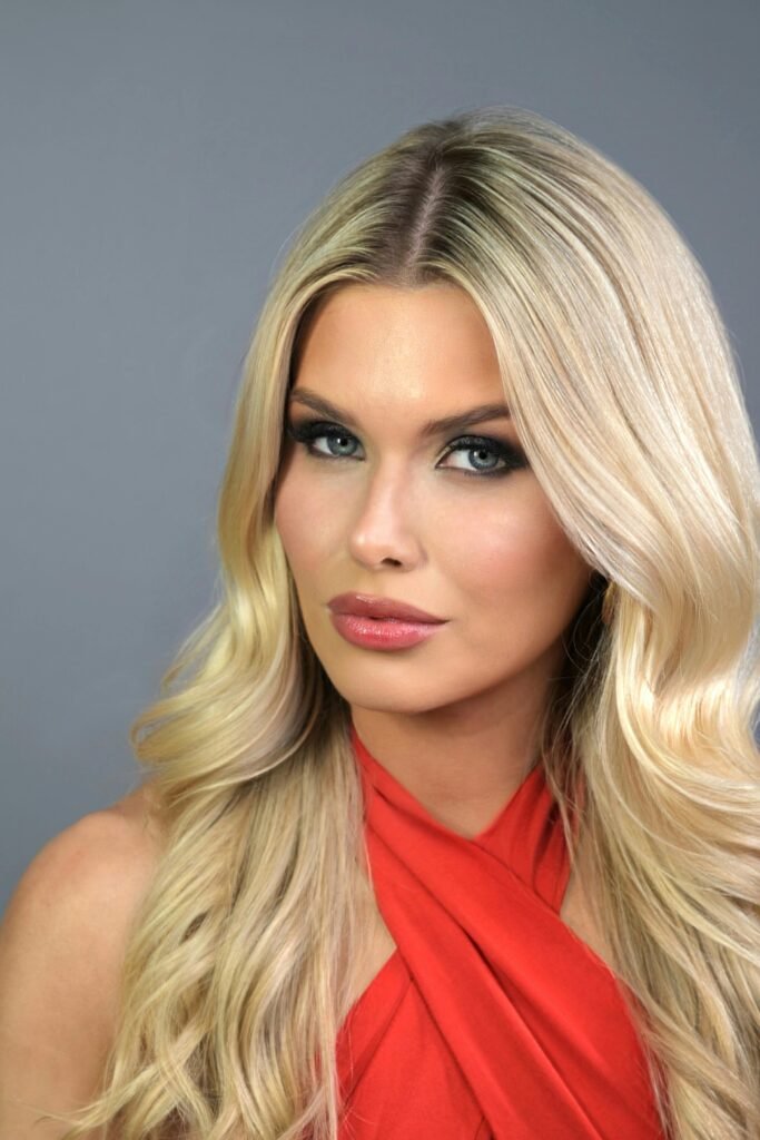 foto de perfil de mulher loira olhos azuis maquiada cabelos loiros lisos soltos vestido vermelho