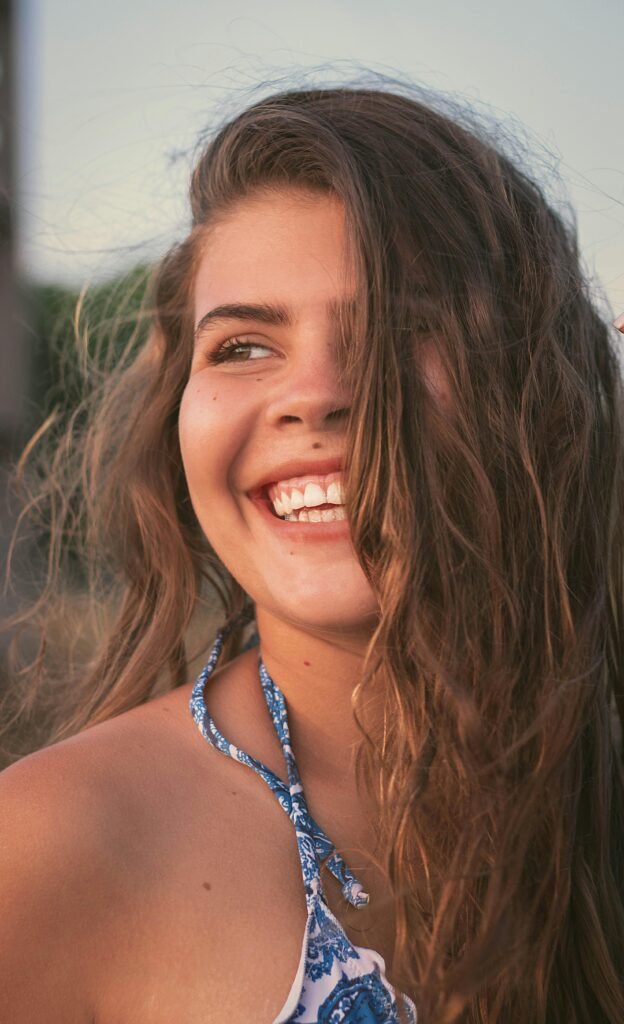 mulher sorrindo olhos castanhos claros cabelos lisos longos soltos