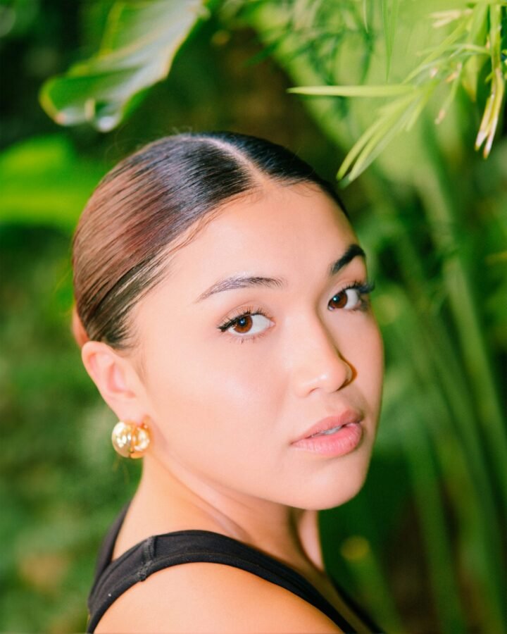 mulher com penteado clean girl preso com gel brinco pequeno dourado blusinha preta foto de Wesley Tingey unsplash.com