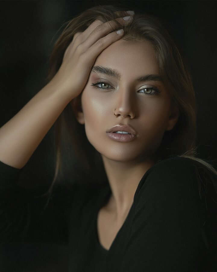 mulher maquiada cabelos castanhos lisos longos blusinha preta pearcing no nariz foto de mahdi chaghari unsplasn.com